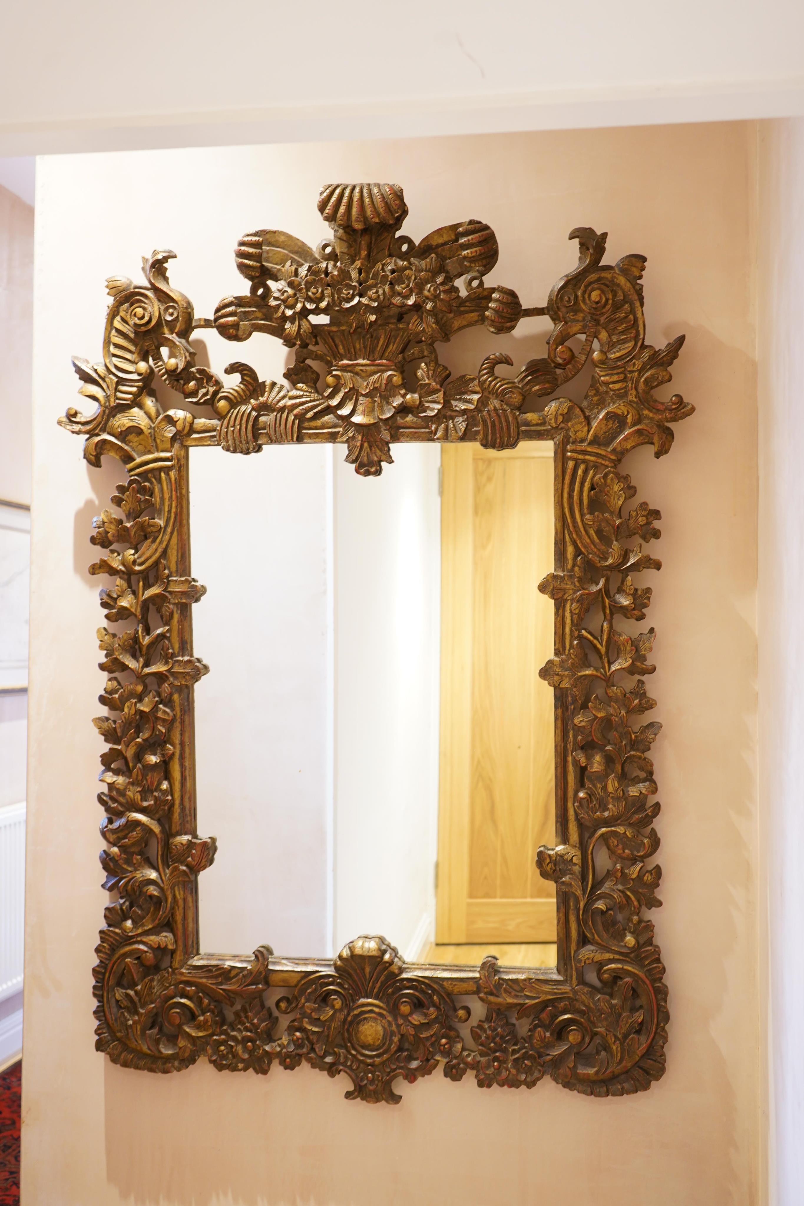 A late 19th century Anglo Indian elaborate carved and giltwood wall mirror, width 109cm, height 155cm. Condition - good